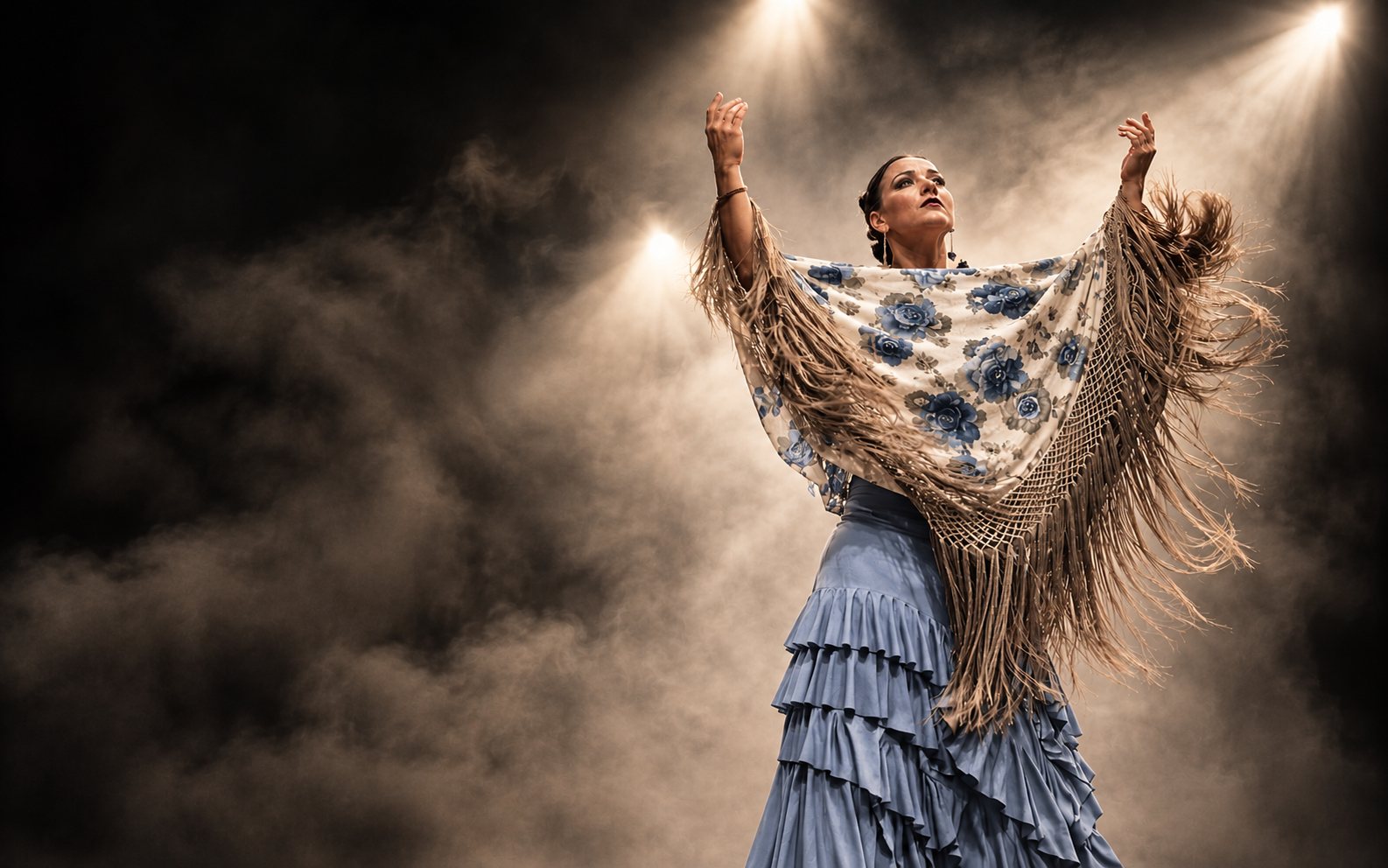 Dancer displaying a patterned shawl over a blue skirt