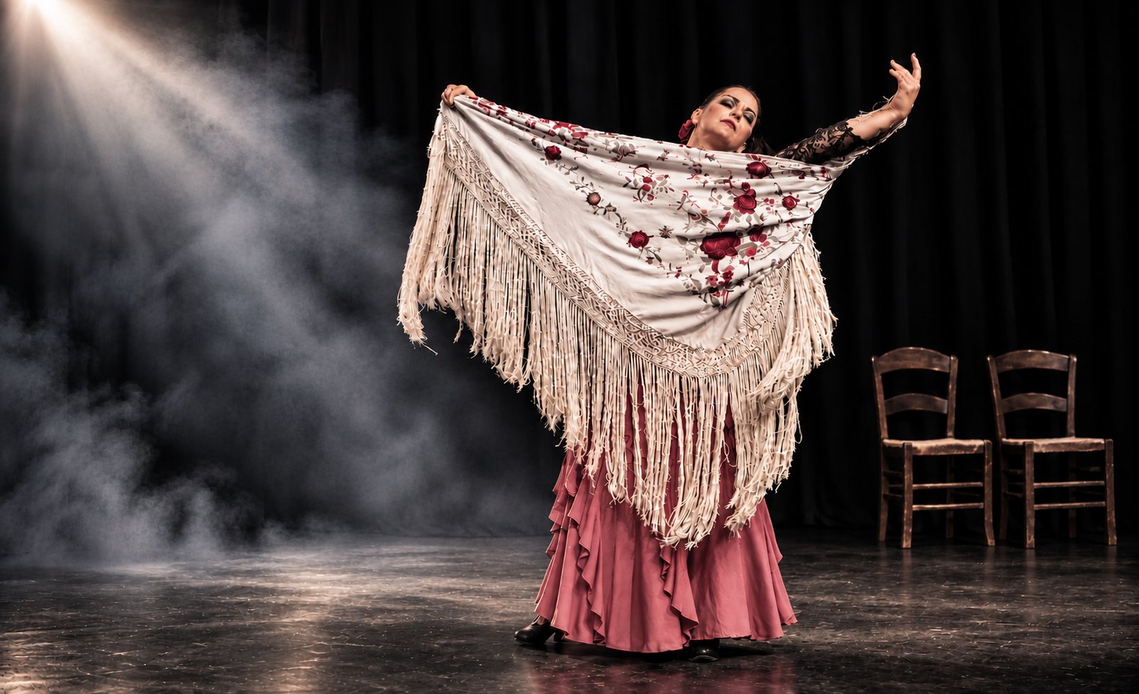 Dancer holding an embroidered cream shawl